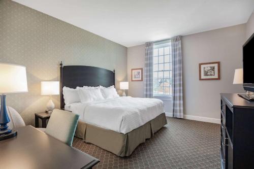 a large hotel room with a bed and a desk at Natural Bridge Hotel, Trademark Collection by Wyndham in Natural Bridge