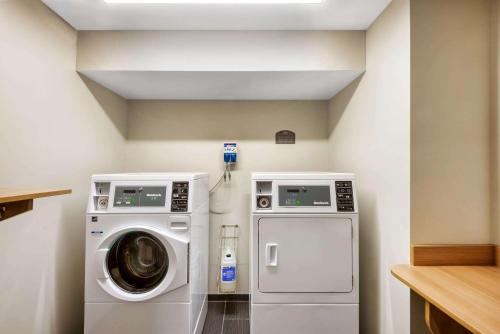 a laundry room with a washer and a dryer at Microtel Inn & Suites by Wyndham Farmington in Canandaigua