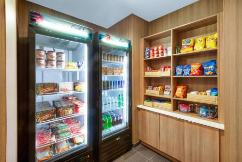 a kitchen with an open refrigerator with food in it at Microtel Inn & Suites by Wyndham Farmington in Canandaigua