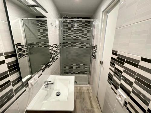a bathroom with a sink and a shower at Sant Adria Beach apartment Wi-Fi Parking Free in Sant Adria de Besos