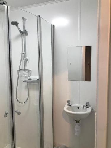a bathroom with a shower and a sink at Harbour bridge, Camps bar in Wick