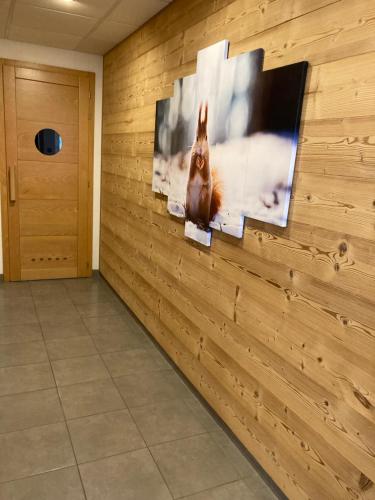 a wall with a picture of a squirrel on it at Le Domaine des Fleurs - Appartement La Gentiane in Gérardmer