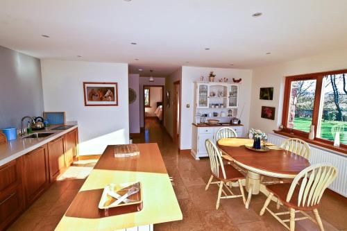 a kitchen and dining room with a table and chairs at Anglers Retreat in Brechin