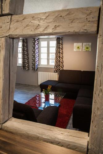 a living room with a couch and a table at Appartements Le Hupsa Pfannala in Saint-Hippolyte