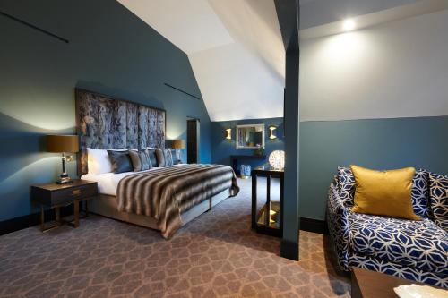 a bedroom with a bed and a chair at Aldwark Manor Estate in Aldwark