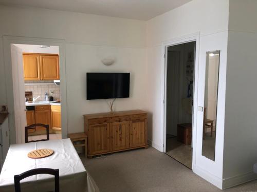 un salon avec une télévision sur un mur dans l'établissement Little Mont Blanc - Saint Gervais, à Saint-Gervais-les-Bains