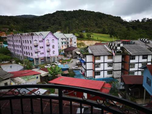 a group of buildings in a town with a mountain at CAMERON TROPICA HOMESTAY in Cameron Highlands