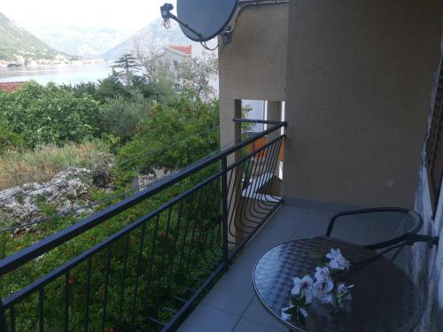 a balcony with a table and a view of a river at Apartments Jovanovic - Alkima in Kotor
