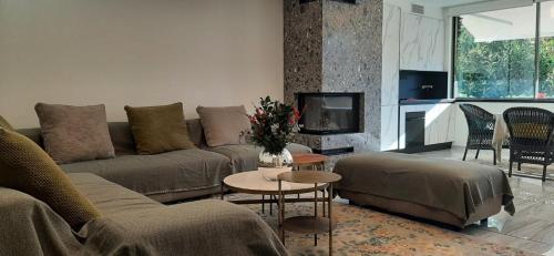 a living room with a couch and a table at Sandy's Superior Suite in Ancient Epidavros