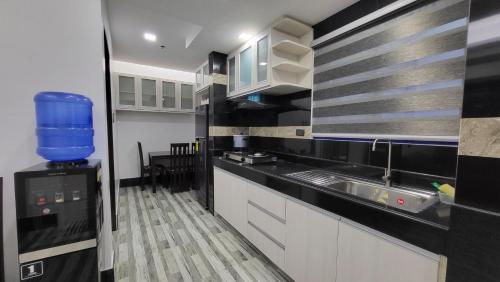 a kitchen with a sink and a counter top at Finteo Skylands Premium in Baguio