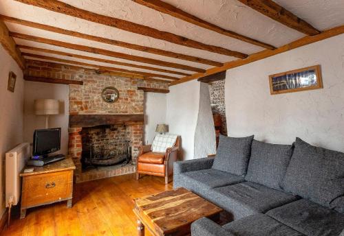 a living room with a couch and a fireplace at Bay Cottage in Broadstairs - Exclusive unmissable deals! Book now before it's too late! in Broadstairs