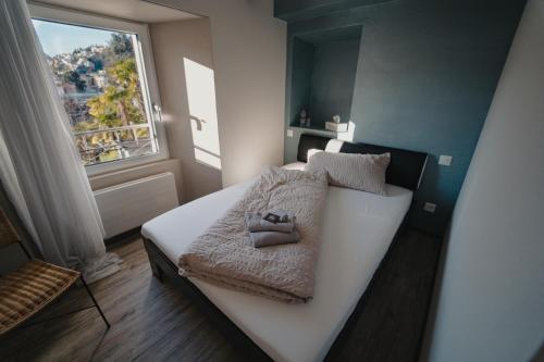 a small bedroom with a bed with a window at Stalder Meat & Bed in Muralto
