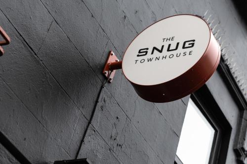 a sign on a wall that reads the arrive downtown at The Snug Townhouse in Galway
