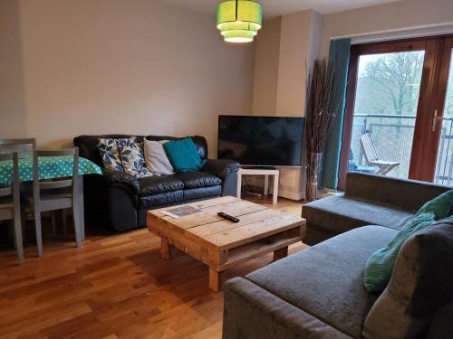 a living room with a couch and a coffee table at The Rampling's in Crawley