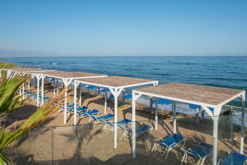 a group of tables and chairs on the beach at Rethymno Mare & Water Park in Rethymno Town