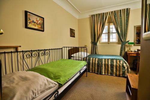 a bedroom with two beds and a window at U Schnellu in Prague
