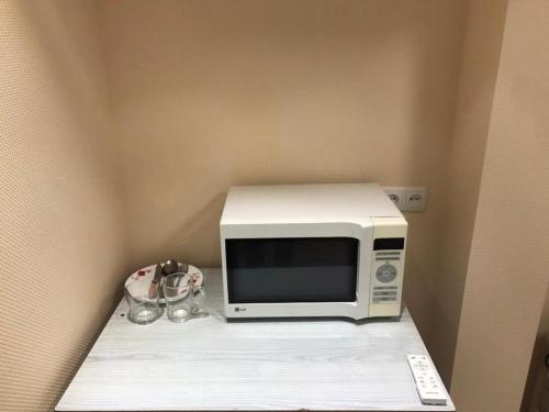 a microwave sitting on a shelf in a room at Harmony on Andrew descent in Kyiv
