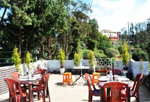 a group of tables and chairs on a patio at EDEN Paradisee in Ooty