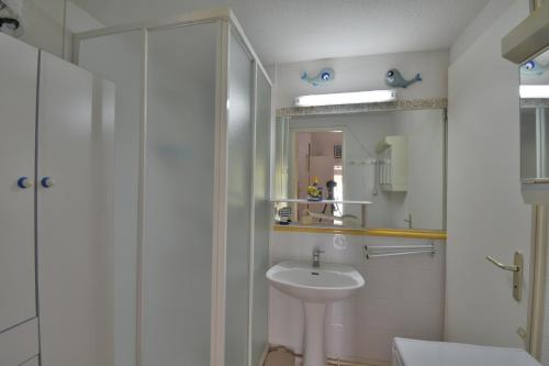 ein weißes Badezimmer mit Waschbecken und Dusche in der Unterkunft MARINES DU ROUSSILLON Villa en résidence avec piscine à 150 m de la plage v100 in Saint-Cyprien