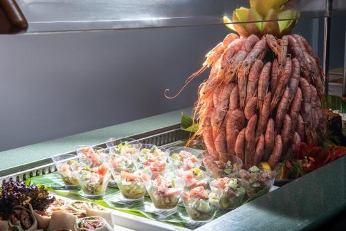 a display with a bunch of sausages and salads at Rethymno Mare Royal & Water Park in Skaleta