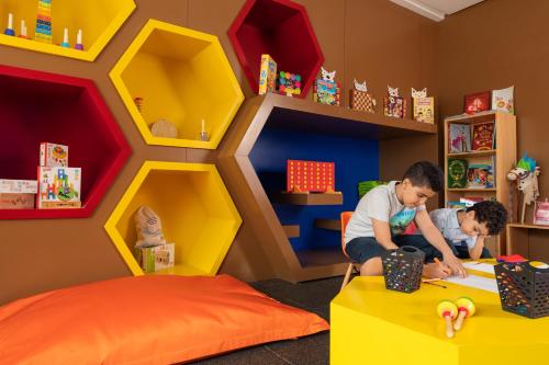 two children playing in a lego room at Marchica Lagoon Resort in Nador