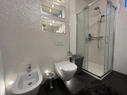 a bathroom with a toilet and a sink and a shower at Apartment Lui with rooftop swimming pool in Ičići