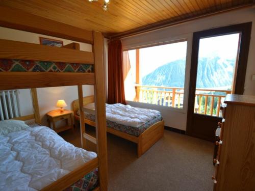 a bedroom with two bunk beds and a balcony at Appartement Courchevel 1850, 3 pièces, 6 personnes - FR-1-514-40 in Courchevel