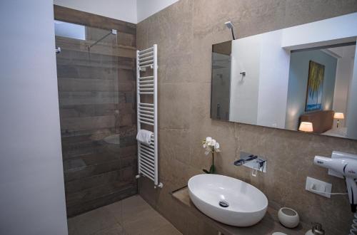 a bathroom with a sink and a mirror at B&B Le Muse in Mondello