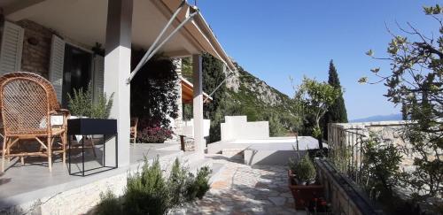 a patio of a house with a table and chairs at Les Villas de Qeparo in Qeparo