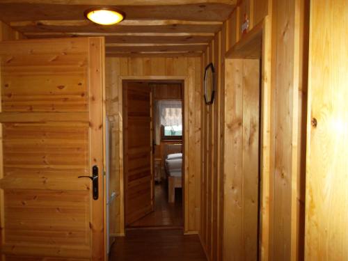 a hallway leading to a bedroom in a log cabin at Chata Sipkova I in Terchová