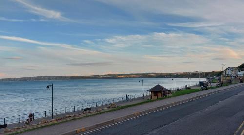 an empty road next to a body of water at Daffodil Guest House in Filey