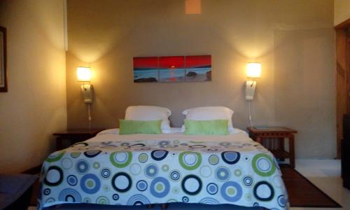 a bedroom with a large bed with two pillows at Colonial Cocoon Studio and Apartement in La Gaulette