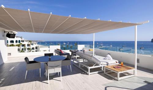 a patio with a canopy and a table and chairs at ME Cabo by Meliá in Cabo San Lucas