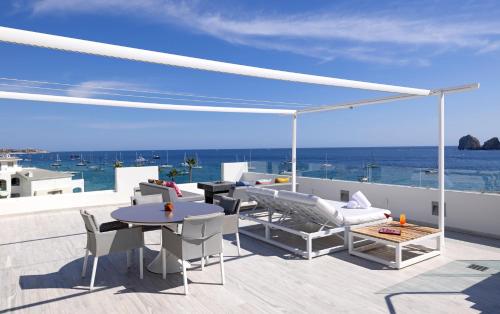 a patio with a view of the ocean at ME Cabo by Meliá in Cabo San Lucas