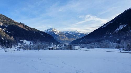 a snow covered field with mountains in the background at Apartment Mölltaler Gletscher 6 in Ausserfragant