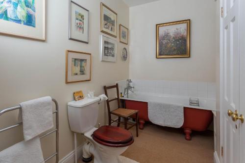 a bathroom with a toilet and a bath tub at Ingram House Bed & Breakfast in Alnwick