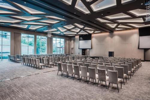 a room with rows of chairs and a stage at Paradox Vancouver in Vancouver