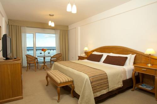 a hotel room with a bed and a television at Hotel Piren in Puerto Madryn