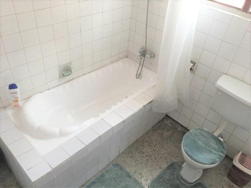 a bathroom with a bath tub and a toilet at Feel At Home & be close to the Labadi Beach (5min) in Accra