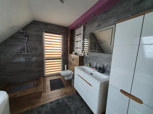 a bathroom with a sink and a toilet at Nowy Dom Apartament z Widokiem na Góry 8 osób in Bielsko-Biała