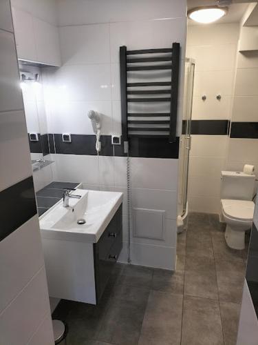 a bathroom with a sink and a toilet at Hotel Chmielna Warsaw in Warsaw