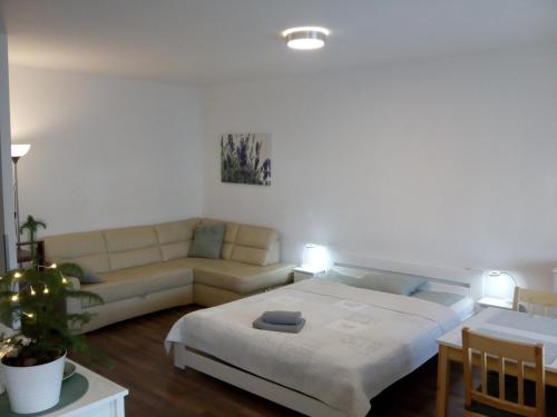 a living room with a bed and a couch at Przytulny Apartament in Szczecin