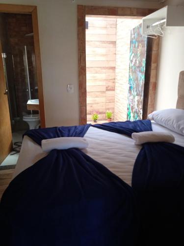 Una cama o camas en una habitación de Pousada Lótus