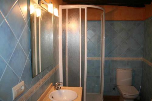 a bathroom with a sink and a toilet and a mirror at Ca lAntic Joanet in Mirambell