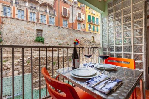 a table with a bottle of wine on a balcony at Tarragona Circus in Tarragona