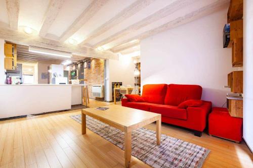 a living room with a red couch and a table at Tarragona Circus in Tarragona