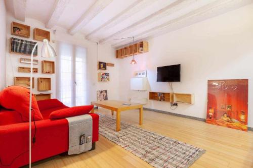 a living room with a red couch and a table at Tarragona Circus in Tarragona
