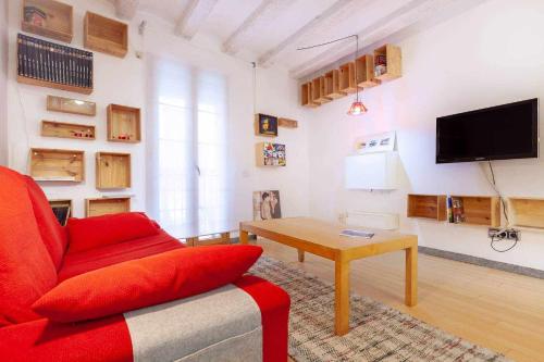 a living room with a red couch and a table at Tarragona Circus in Tarragona
