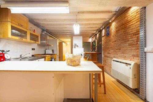 a kitchen with a counter and a brick wall at Tarragona Circus in Tarragona
