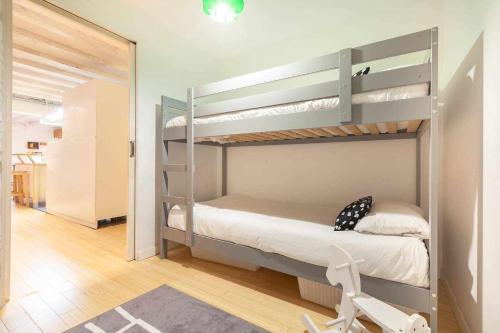 a bedroom with two bunk beds and a chair at Tarragona Circus in Tarragona